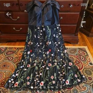 Women's satin off shoulder dress in black with wildflowers and butterflies.